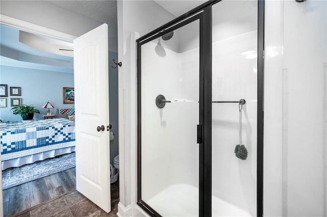 ensuite bathroom with toilet, a stall shower, and ensuite bathroom