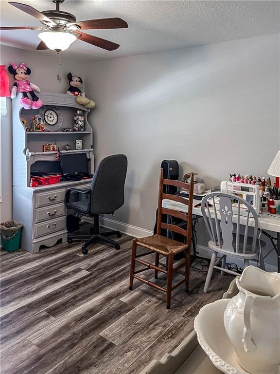 office area featuring wood finished floors, a textured ceiling, and ceiling fan