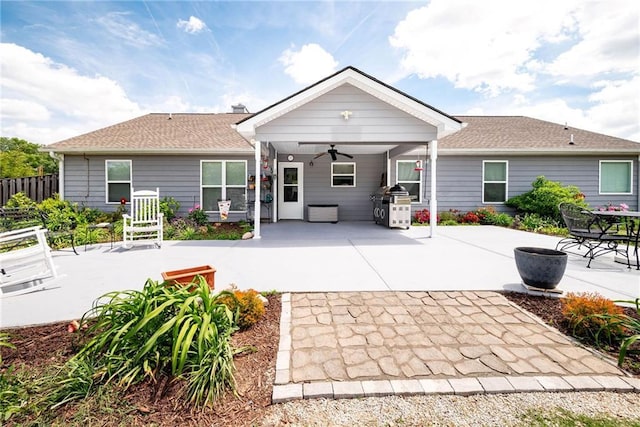 rear view of house featuring fence, a ceiling fan, and a patio