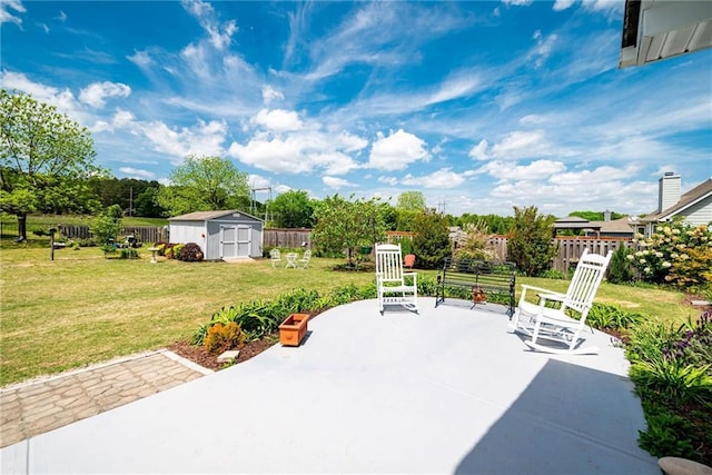 view of patio / terrace featuring a fenced backyard, an outdoor structure, and a shed