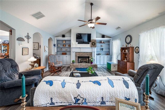 bedroom with lofted ceiling, wood finished floors, and visible vents