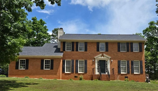 639 Royal Abbey Dr, Stone Mountain, GA 30088 - colonial inspired home with a chimney, a front yard, and brick siding