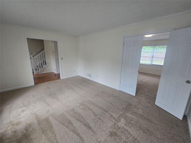 639 Royal Abbey Dr, Stone Mountain, GA 30088 - spare room with carpet flooring, baseboards, and stairs