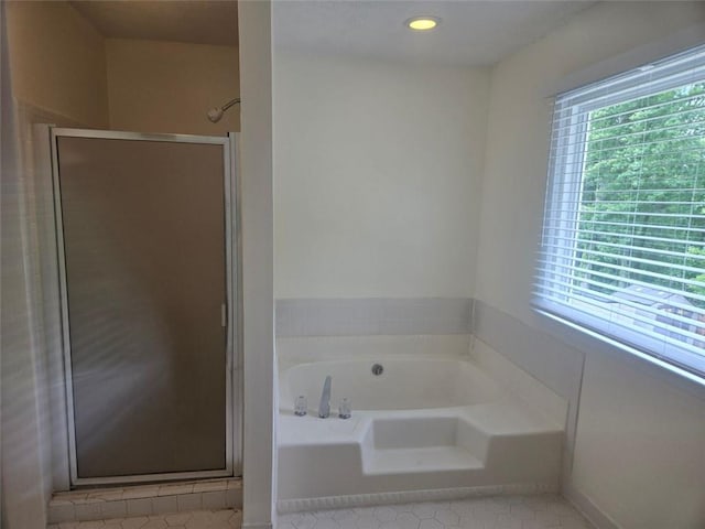 639 Royal Abbey Dr, Stone Mountain, GA 30088 - bathroom featuring tile patterned floors, a shower stall, and a garden tub