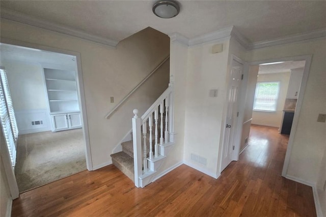 639 Royal Abbey Dr, Stone Mountain, GA 30088 - stairway featuring crown molding, hardwood / wood-style floors, and built in features