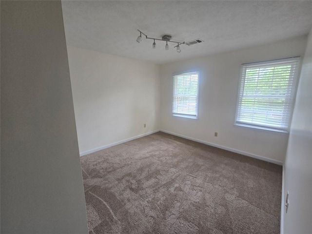 639 Royal Abbey Dr, Stone Mountain, GA 30088 - carpeted empty room with baseboards and rail lighting