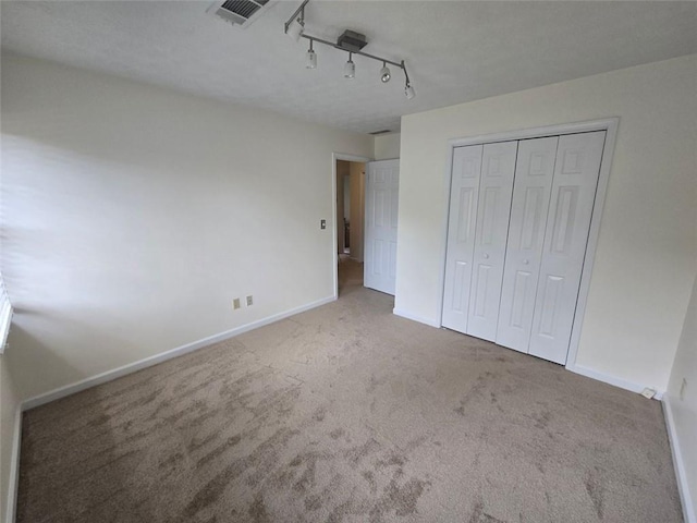 639 Royal Abbey Dr, Stone Mountain, GA 30088 - unfurnished bedroom featuring carpet floors, baseboards, and a closet