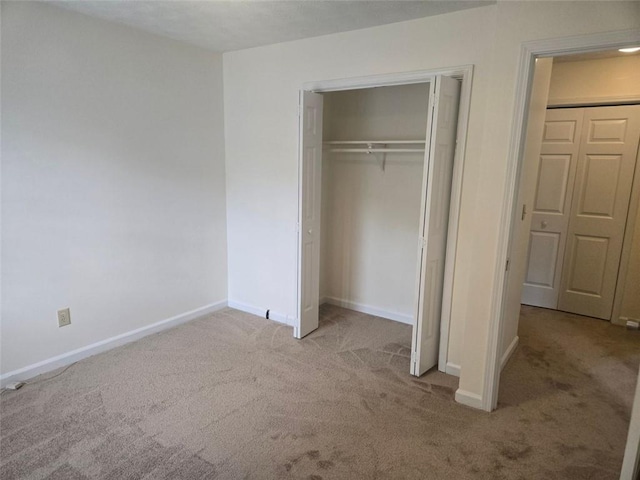 639 Royal Abbey Dr, Stone Mountain, GA 30088 - unfurnished bedroom with carpet flooring, a closet, and baseboards