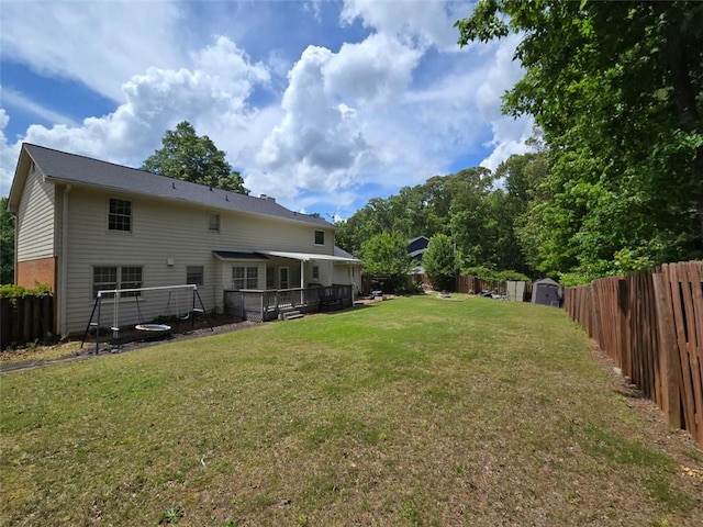 639 Royal Abbey Dr, Stone Mountain, GA 30088 - rear view of house with a storage unit, an outbuilding, and a wooden deck