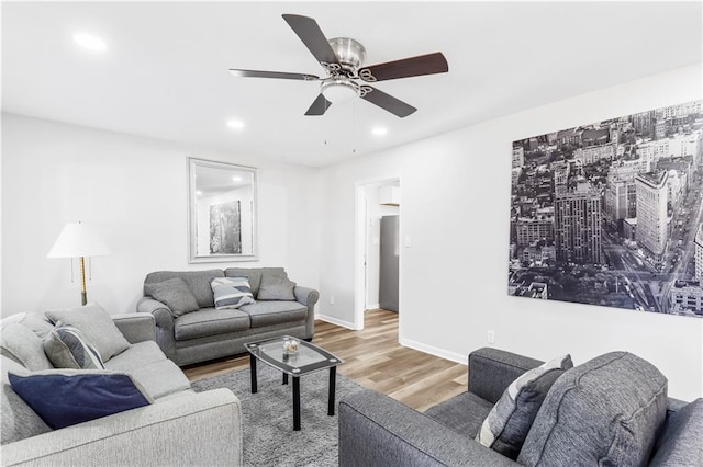 living room featuring hardwood / wood-style floors and ceiling fan