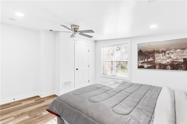 bedroom with light wood-type flooring and ceiling fan