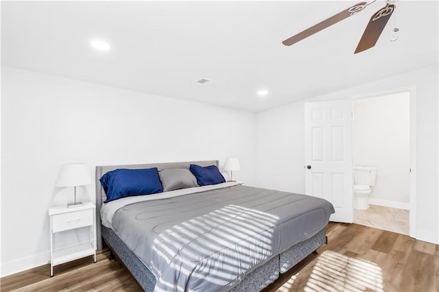 bedroom with hardwood / wood-style flooring, ceiling fan, lofted ceiling, and ensuite bathroom