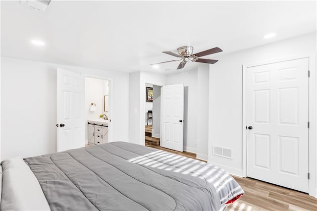 bedroom with connected bathroom, ceiling fan, a closet, and light wood-type flooring