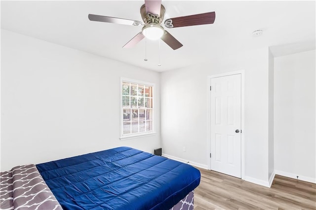 bedroom with ceiling fan and hardwood / wood-style floors