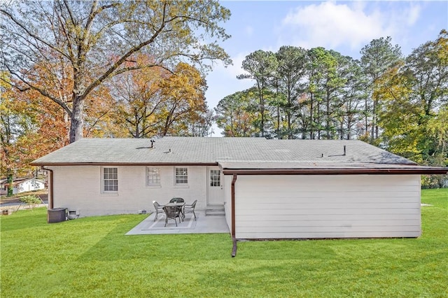 back of house with a lawn, central air condition unit, and a patio