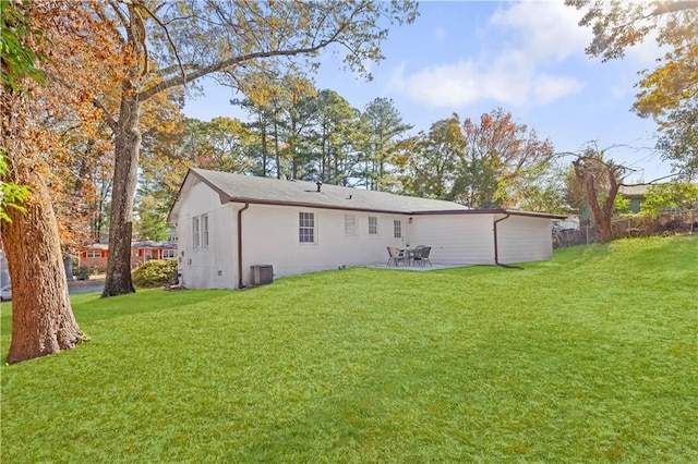 rear view of house with a patio area, a yard, and central AC unit