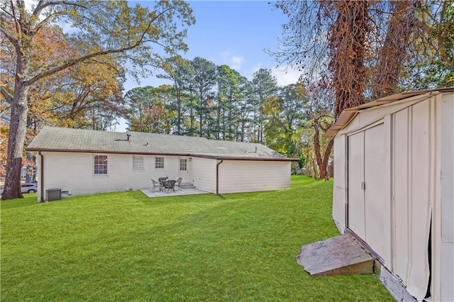 rear view of property with a lawn, a shed, and central air condition unit