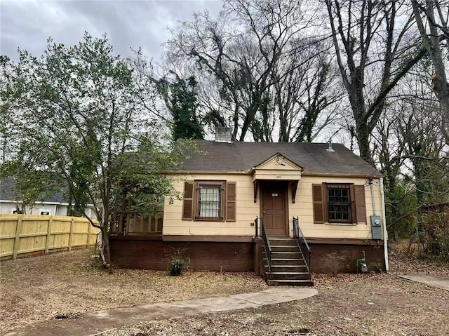 view of front of home with fence and a chimney