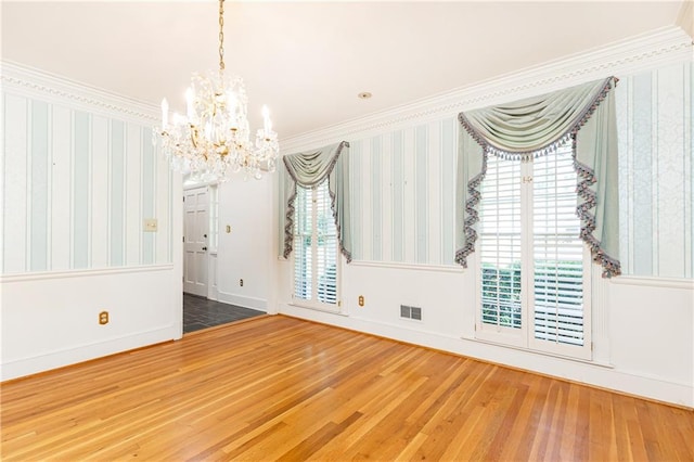 5287 Vernon Lake Dr, Atlanta, GA 30338 - unfurnished room with a chandelier, wallpapered walls, wood finished floors, crown molding, and baseboards