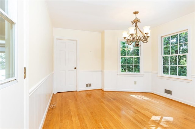 5287 Vernon Lake Dr, Atlanta, GA 30338 - spare room with a chandelier, light wood-style flooring, plenty of natural light, and a wainscoted wall
