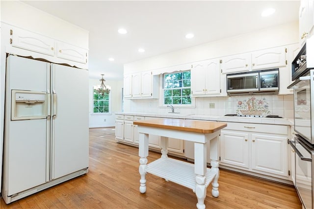 5287 Vernon Lake Dr, Atlanta, GA 30338 - kitchen featuring white appliances, white cabinets, healthy amount of natural light, and recessed lighting