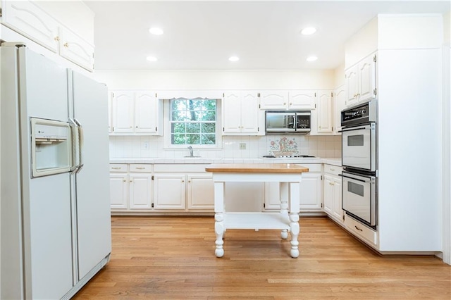 5287 Vernon Lake Dr, Atlanta, GA 30338 - kitchen with white appliances, light countertops, white cabinetry, decorative backsplash, and recessed lighting