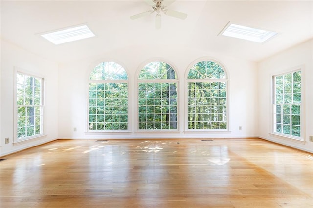 5287 Vernon Lake Dr, Atlanta, GA 30338 - empty room featuring a skylight, healthy amount of natural light, wood finished floors, a ceiling fan, and vaulted ceiling