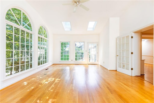 5287 Vernon Lake Dr, Atlanta, GA 30338 - unfurnished living room featuring vaulted ceiling, wood finished floors, ceiling fan, a skylight, and baseboards