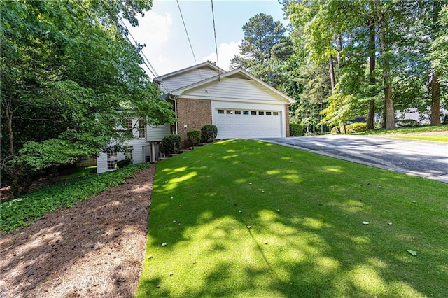 5287 Vernon Lake Dr, Atlanta, GA 30338 - view of side of home with asphalt driveway, brick siding, a lawn, and an attached garage