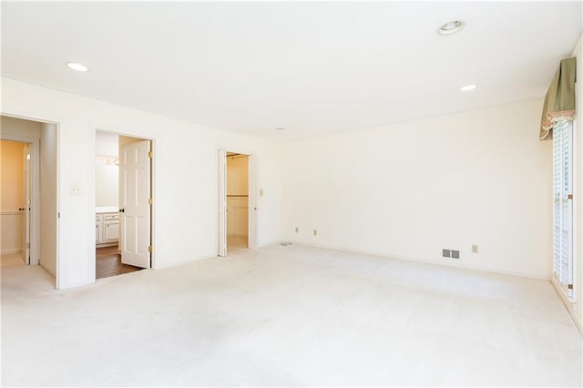 5287 Vernon Lake Dr, Atlanta, GA 30338 - unfurnished bedroom featuring light colored carpet, a walk in closet, recessed lighting, baseboards, and a closet