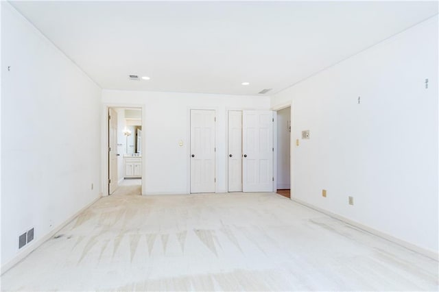 5287 Vernon Lake Dr, Atlanta, GA 30338 - unfurnished bedroom featuring two closets, light colored carpet, connected bathroom, recessed lighting, and baseboards