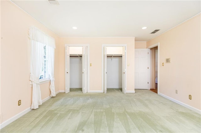 5287 Vernon Lake Dr, Atlanta, GA 30338 - unfurnished bedroom featuring two closets, light colored carpet, ornamental molding, baseboards, and recessed lighting