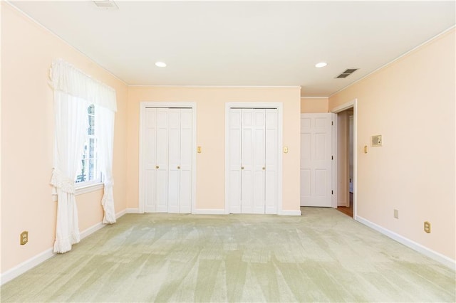 5287 Vernon Lake Dr, Atlanta, GA 30338 - unfurnished bedroom with multiple closets, light carpet, ornamental molding, recessed lighting, and baseboards