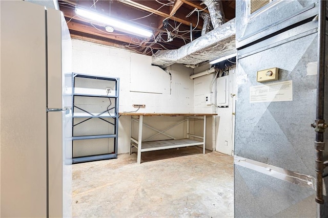 5287 Vernon Lake Dr, Atlanta, GA 30338 - unfinished basement with freestanding refrigerator, a workshop area, electric panel, and heating unit