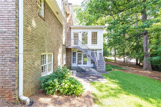 5287 Vernon Lake Dr, Atlanta, GA 30338 - back of property with stairs, brick siding, a yard, a patio area, and a wooden deck