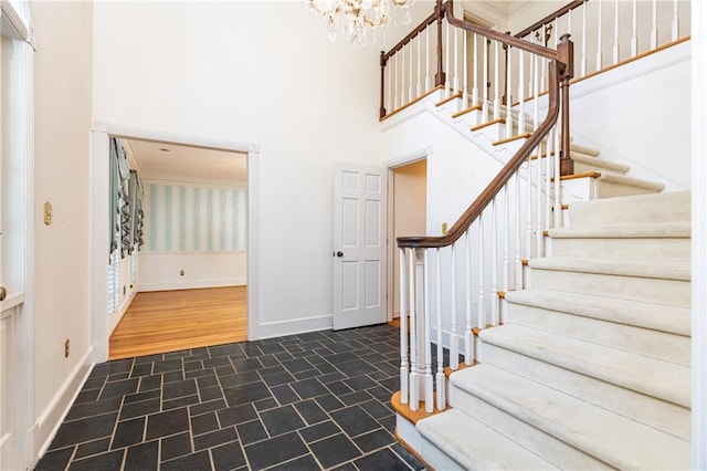 5287 Vernon Lake Dr, Atlanta, GA 30338 - foyer with a chandelier, stairs, a towering ceiling, baseboards, and crown molding