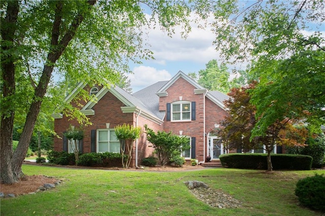 4645 Waterford Dr, Suwanee, GA 30024 - traditional-style house featuring a front lawn and brick siding