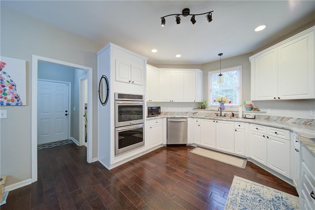 4645 Waterford Dr, Suwanee, GA 30024 - kitchen featuring appliances with stainless steel finishes, a sink, recessed lighting, baseboards, and light stone counters