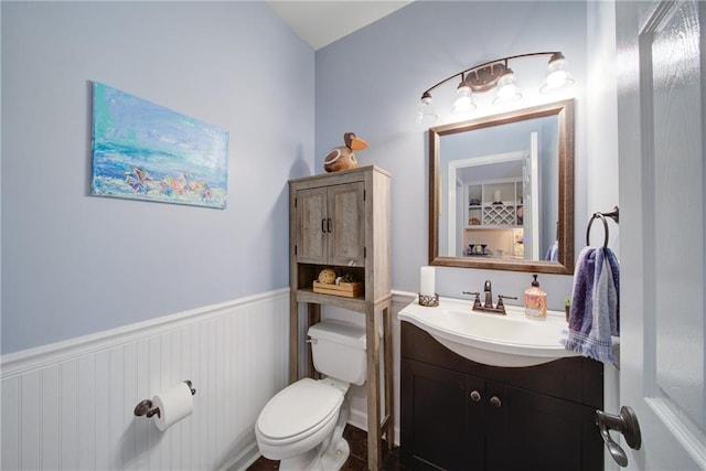 4645 Waterford Dr, Suwanee, GA 30024 - half bathroom featuring toilet, vanity, and a wainscoted wall