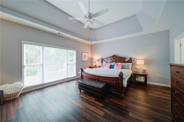 4645 Waterford Dr, Suwanee, GA 30024 - bedroom featuring a tray ceiling, dark wood finished floors, baseboards, and a ceiling fan