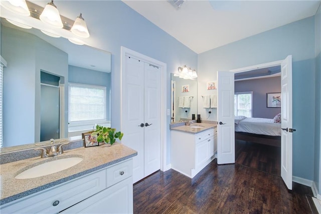 4645 Waterford Dr, Suwanee, GA 30024 - ensuite bathroom featuring wood finished floors, two vanities, a closet, and baseboards