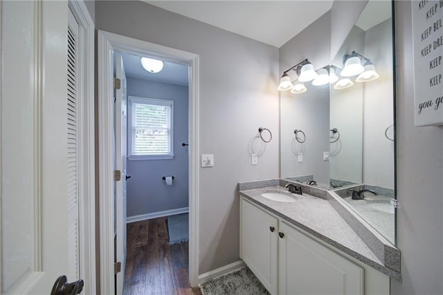 4645 Waterford Dr, Suwanee, GA 30024 - bathroom with wood finished floors, double vanity, and baseboards