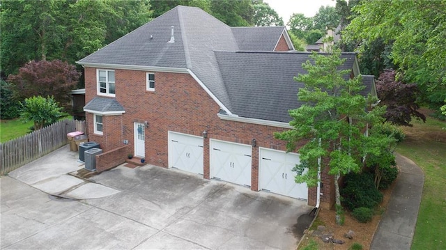 4645 Waterford Dr, Suwanee, GA 30024 - view of side of property with concrete driveway, brick siding, and a shingled roof