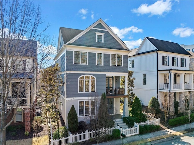 view of front of home featuring a fenced front yard and a balcony