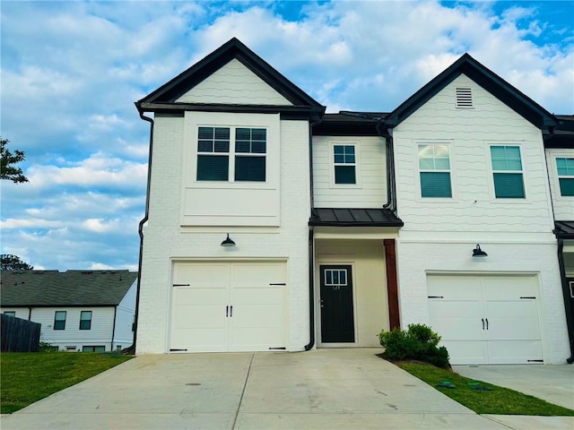townhome / multi-family property with brick siding, concrete driveway, an attached garage, and a standing seam roof