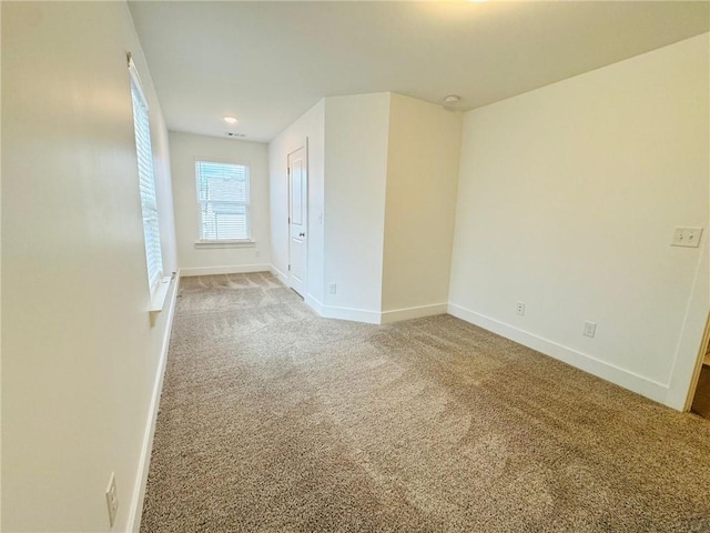 empty room with light carpet and baseboards
