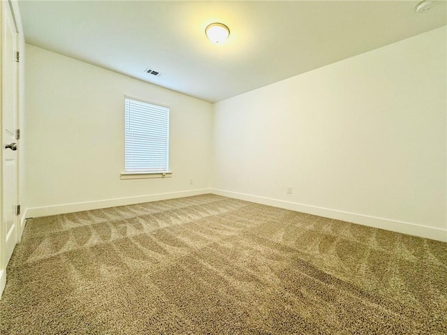 carpeted spare room with baseboards