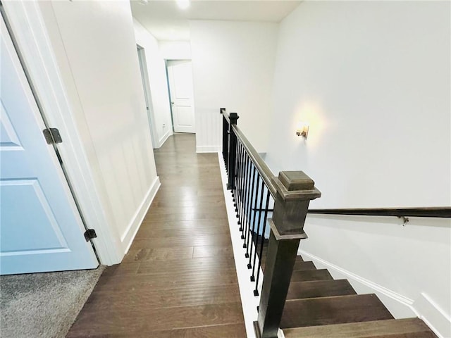 stairs with hardwood / wood-style floors and baseboards