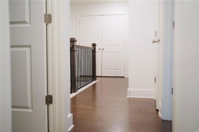 hall with wood finished floors and baseboards