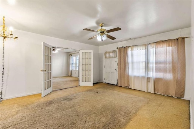 spare room with carpet flooring, french doors, baseboards, and a ceiling fan